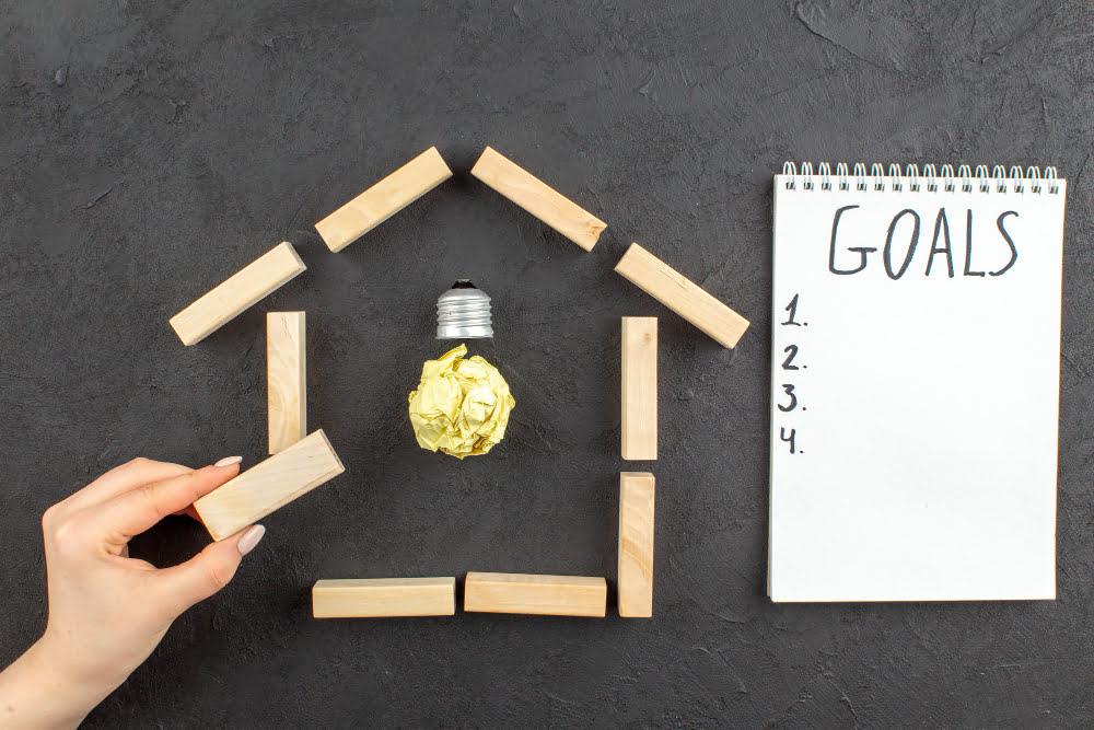 idealight bulb in house shaped wood blocks goals written